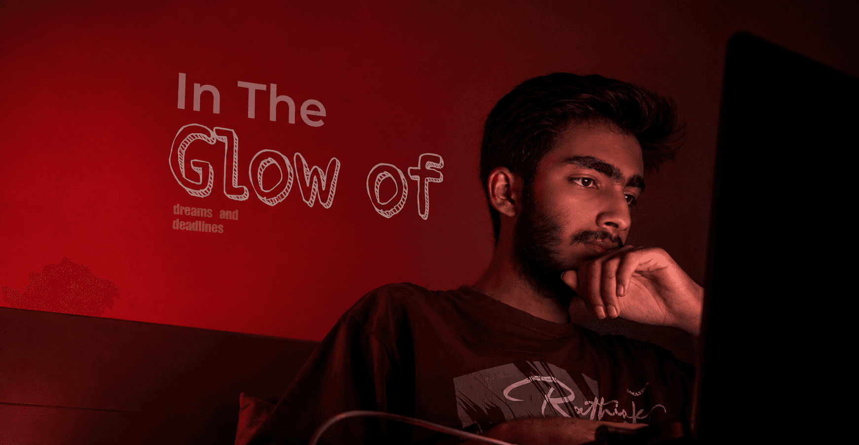 Tasfirul Haque at his desk in red light