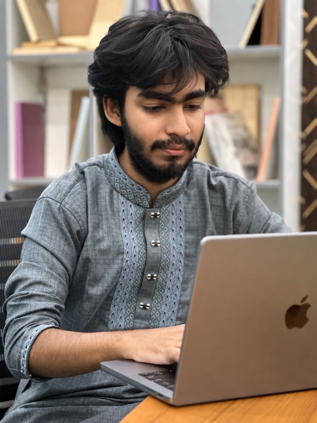 Tasfirul Haque working on his laptop
